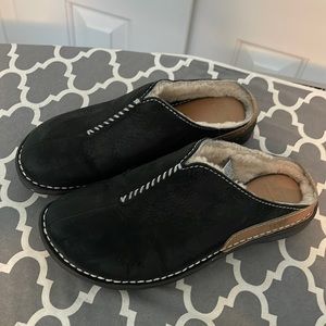 UGG black leather mules with fleece lining, Size 7.